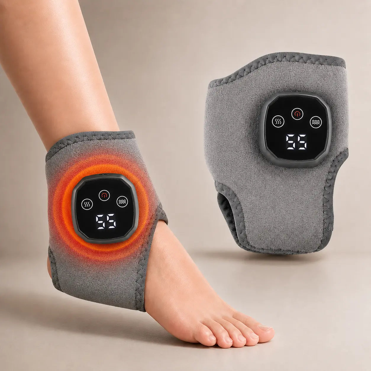 Gray cordless heated ankle and wrist massager wrap with LED display, worn on the wrist