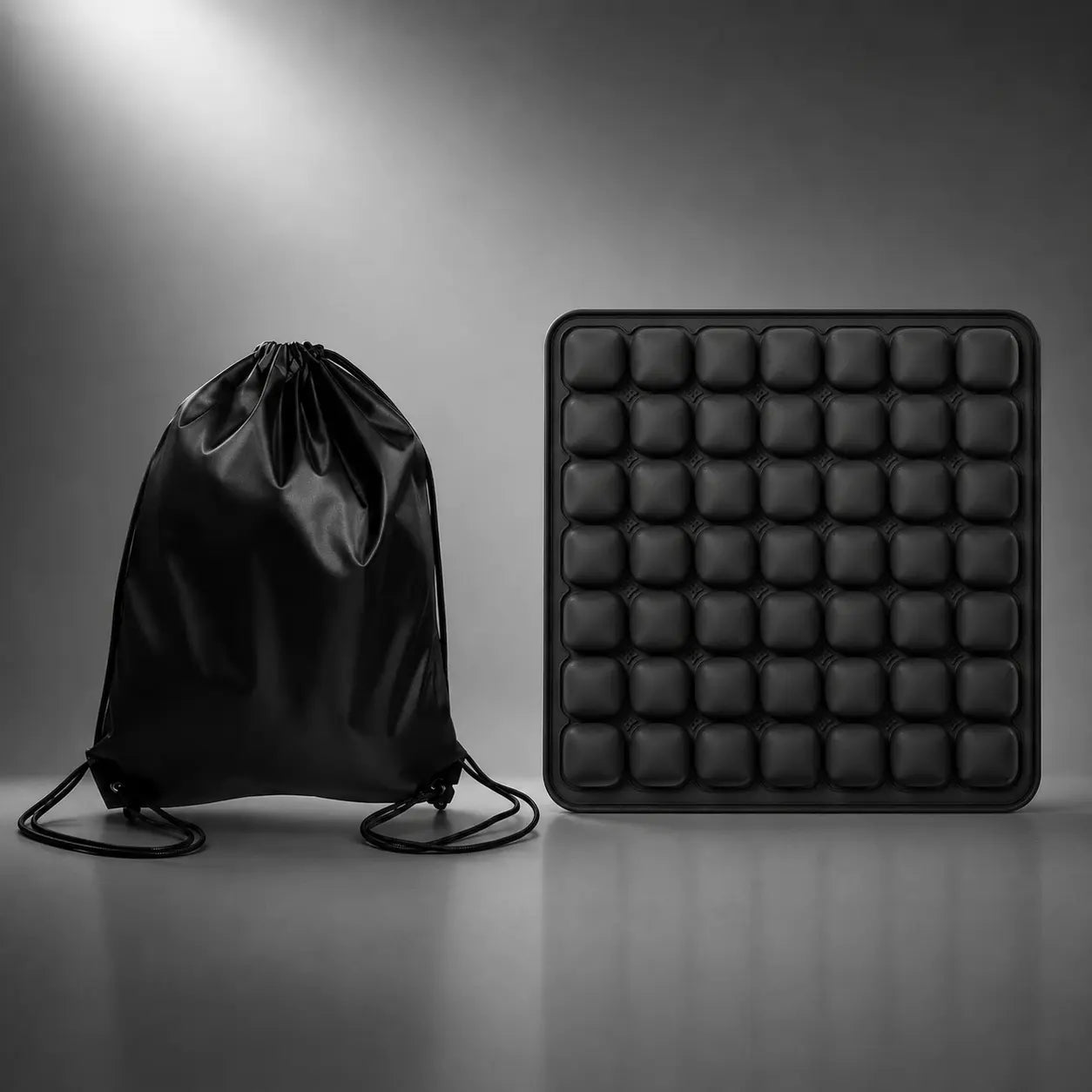 Black inflatable air seat cushion with drawstring carry bag included